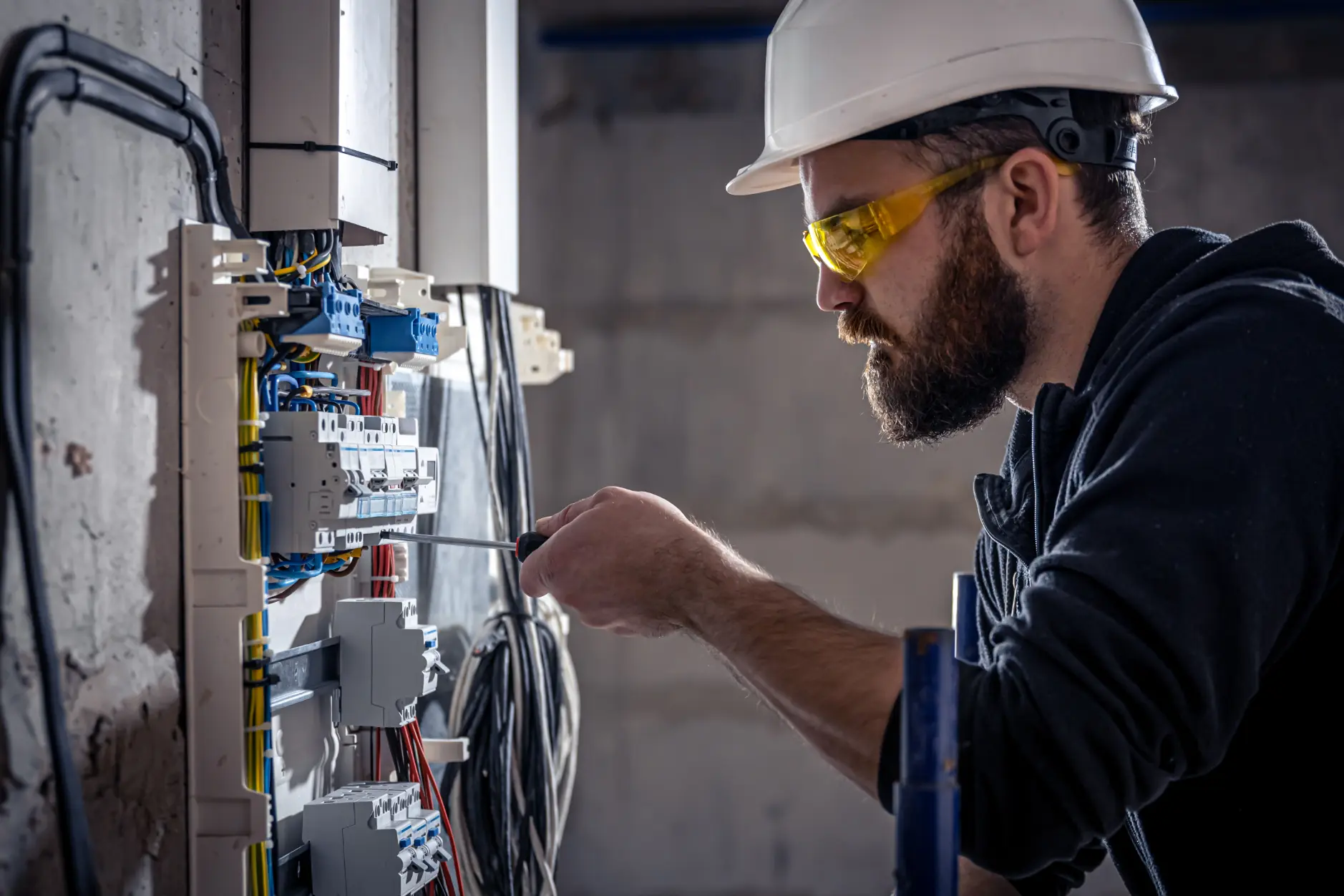 Electrician working on an electrical panel