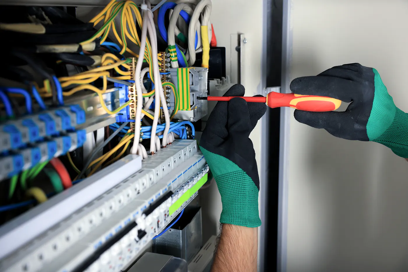 Electrician working inside an electrical consumer unit