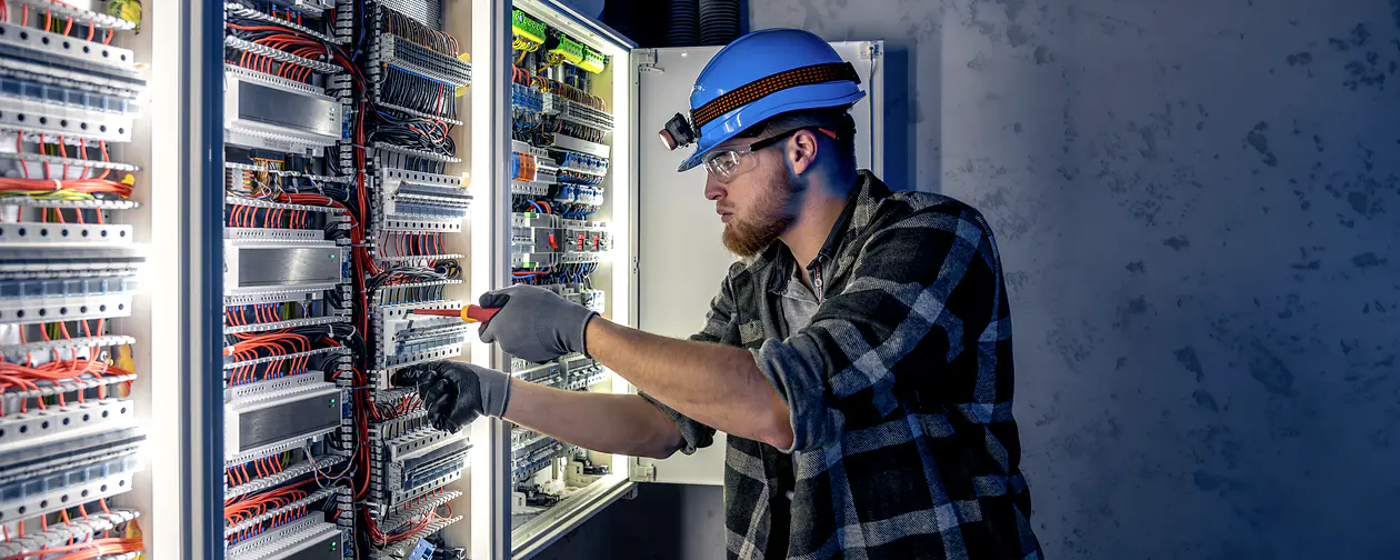 Electrician working on a commercial electrical panel