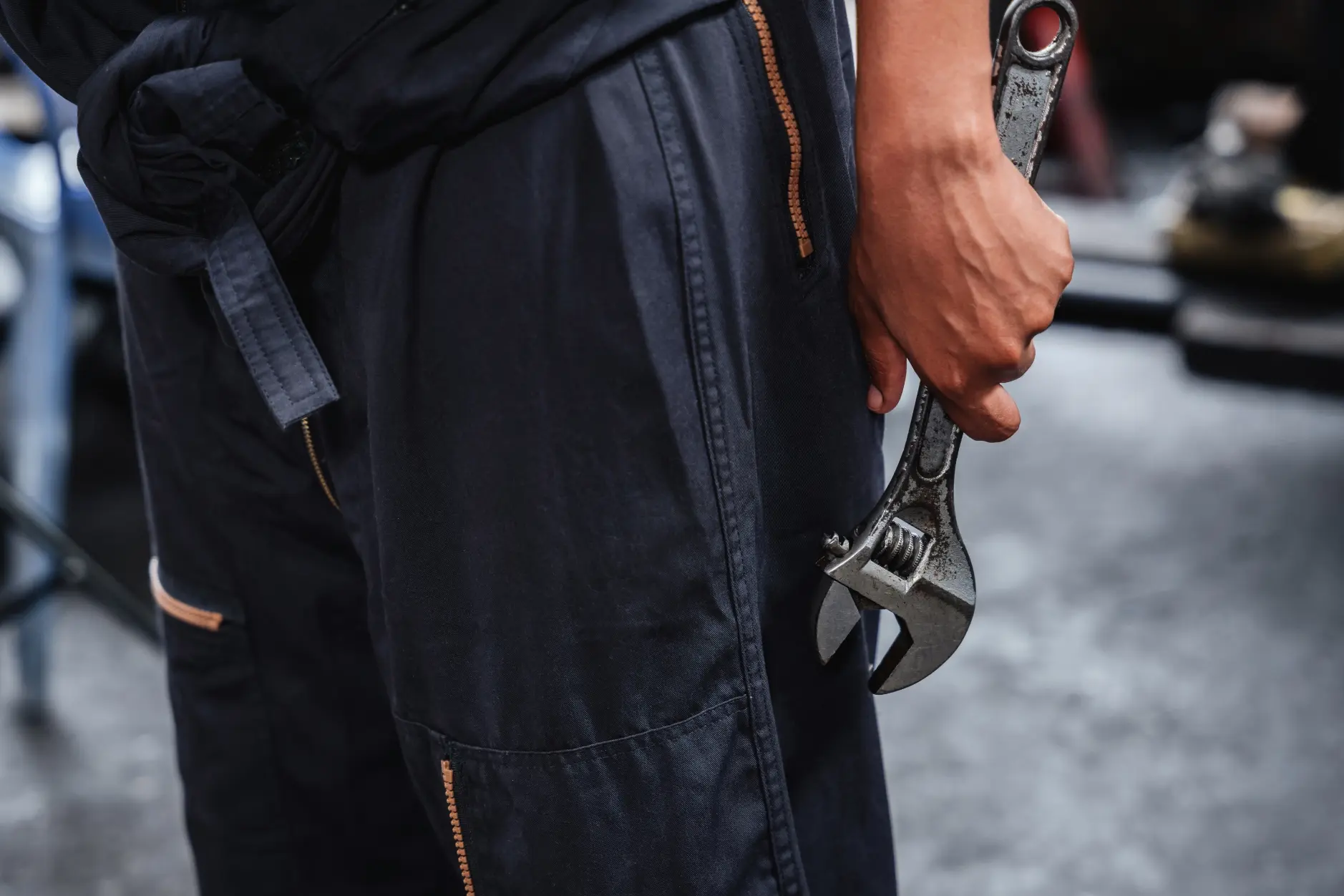 Tradesperson holding an adjustable wrench